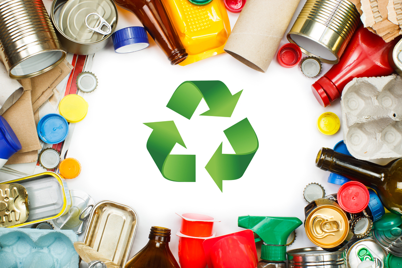 Facilities manager conducts a waste audit, sorting mixed rubbish into labelled recycling categories